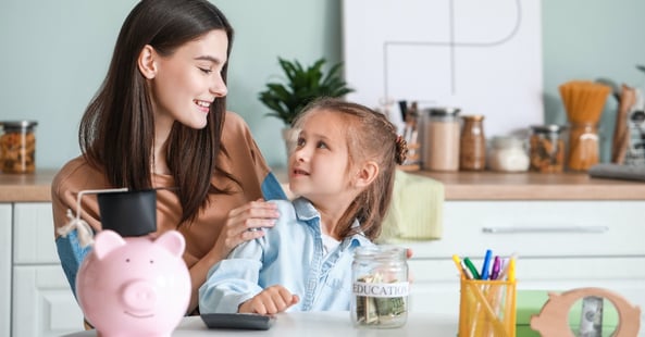 a mom and her daughter metaphorically using a piggy bank for a 529 college savings plan