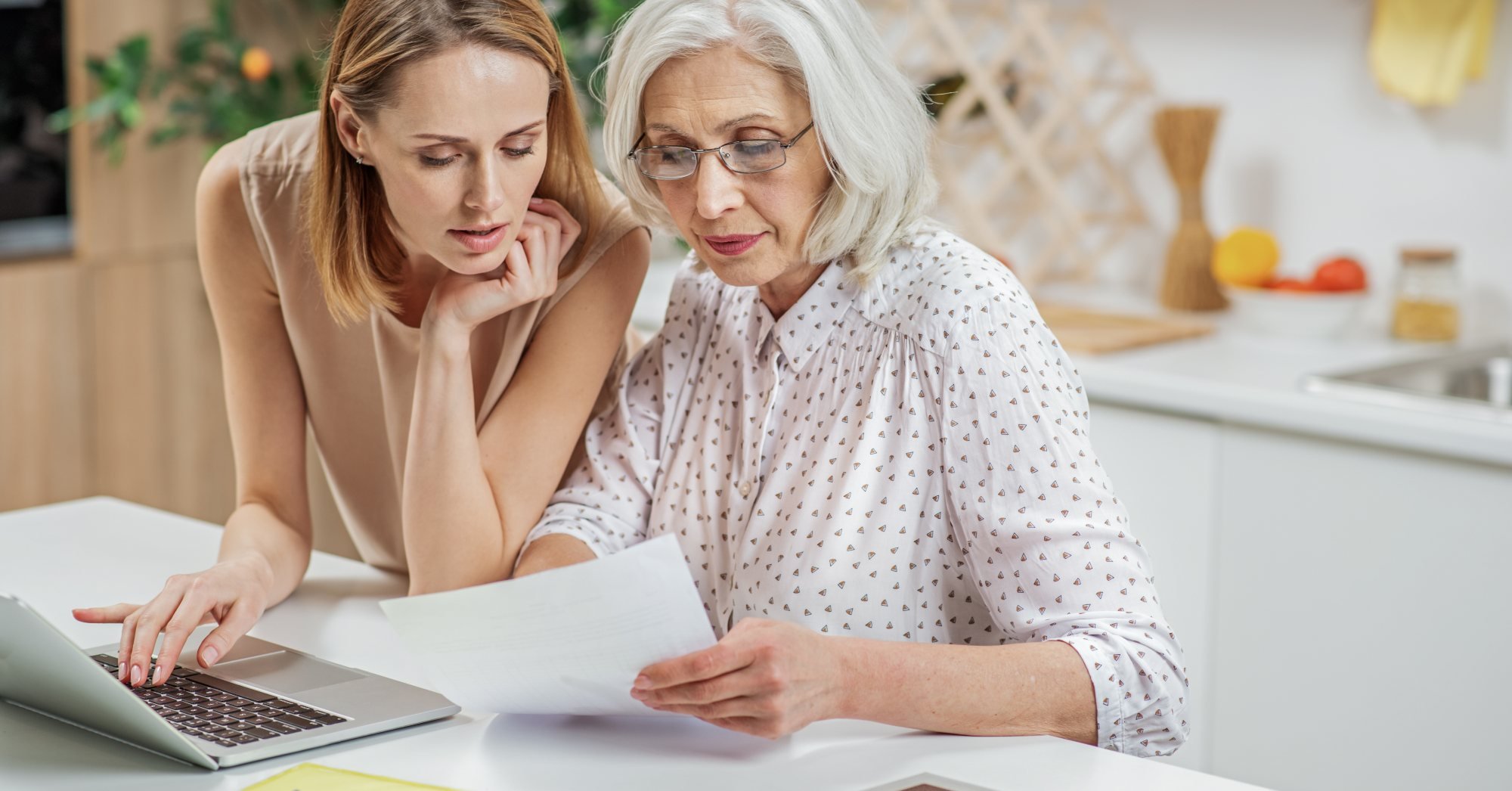 How to Talk to Your Aging Parents About Money - mother and daughter at table – Birchwood